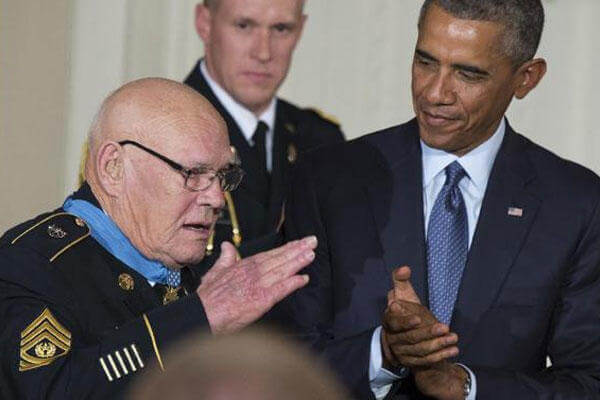 President Barack Obama, right, applauds as retired Army Command Sgt. Maj, Bennie G. Adkins salutes after receiving the Medal of Honor in the East Room of the White House, on Monday, Sept. 15, 2014 (AP Photo/Evan Vucci)