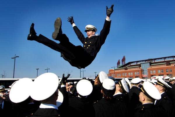 Midshipmen traditionally toss each other in the air after Navy touchdowns. (DoD photo) 