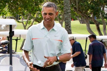 President Obama tosses a golf ball between his hands after finishing a game of golf Wednesday, Dec. 24, 2014, at Marine Corps Base Hawaii's Kaneohe Klipper Golf Course in Kaneohe. (AP Photo/Jacquelyn Martin)