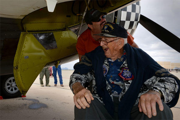 Retired Air National Guard Chief Warrant Officer 2 Robert Hertel, laughs while under the wing of a P-47 Thunderbolt Feb. 28, 2015, at Davis-Monthan Air Force Base, Ariz. (U.S. Air Force photo/Senior Airman Jensen Stidham)