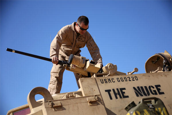 Marine Corps Sgt. Cody Olson assembles an M2 .50-caliber heavy machine gun on an M88A2 Hercules Armored Recovery Vehicle during an exercise Feb. 8, 2015. (U.S. Marine Corps photo by Sgt. Devin Nichols)
