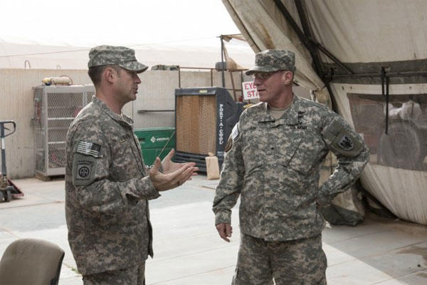 Capt. Thomas Samson, Headquarters Support Company, 90th Aviation Support Battalion commander, talks to Brig. Gen. Troy D. Kok, 11th Aviation Command commander, during his visit to Camp Buehring, Kuwait, Feb. 20, 2015. (U.S. Army photo)