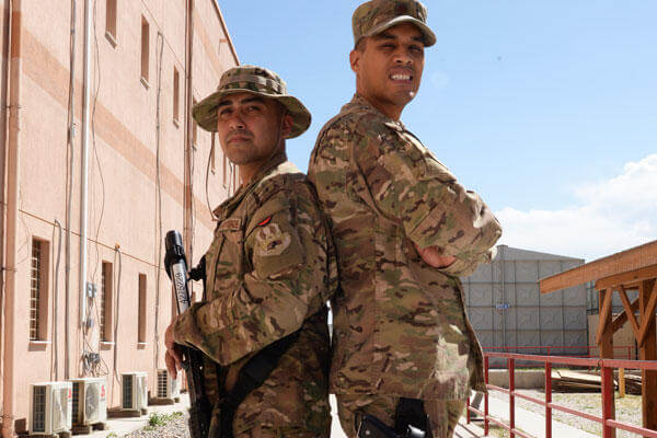 Childhood friends Air Force Staff Sgt. Vincent Fulgencio, left, and Air Force Maj. Gregory Savella pose for a photo at Bagram Airfield, Afghanistan, May 19, 2015. (U.S. Air Force photo by Senior Airman Cierra Presentado)