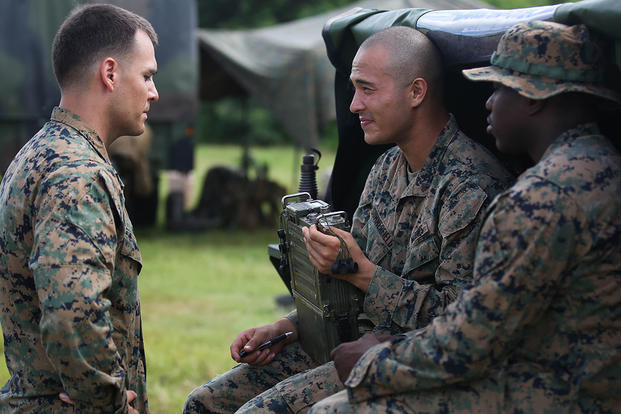 Cpl. Seth Dixon (left) speaks to Cpl. Terry Summerfield (center) and Cpl. John Boyd (right) at the Boondocker Training Area aboard Marine Corps Base Hawaii during training exercise Island Viper, Sept. 22, 2015. Photo By: Lance Cpl. Harley Thomas