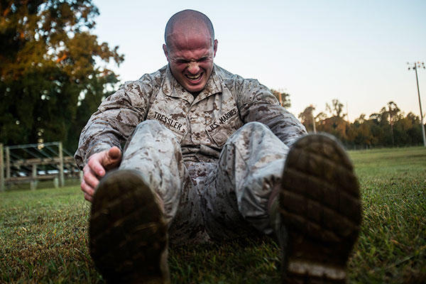 Pfc. Brandon Tressler, scout sniper screener candidate from 3rd Battalion, 6th Marine Regiment, conducts a max set of sit-ups- after completing a 1.5 mile ruck run at Camp Lejeune, N.C., Oct. 20, 2015. (U.S. Marine Corps/Cpl. Kirstin Merrimarahajara)
