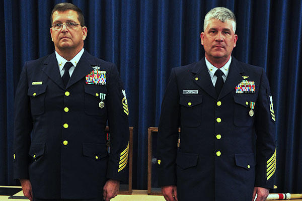 Chief Petty Officer Harvey Gjesdal and Chief Petty Officer Bradley Rodgers are read their departing orders during a joint retirement ceremony Nov. 7, 2015, at Coast Guard Sector Puget Sound in Seattle. (U.S. Coast Guard/PO2 Ayla Kelley)