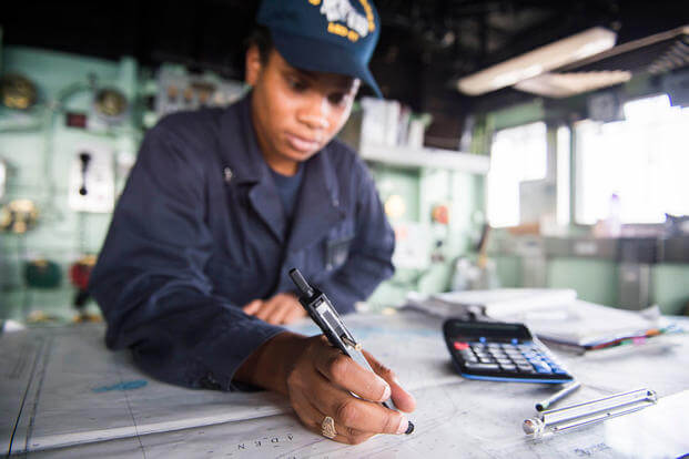 Quartermaster 3rd Class Monica Christopher plots a course aboard the Whidbey Island-class dock landing ship USS Rushmore (LSD 47). (Photo by Mass Communication Specialist 3rd Class Chelsea Troy Milburn)