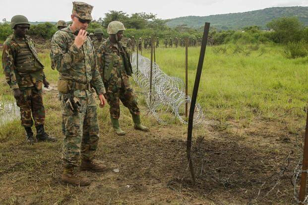 U.S. Marine Staff Sgt. Malachi McPherson and Uganda People’s Defense Force soldiers observe the efficiency of their breach on a razor-wire obstacle during a breaching exercise at Camp Singo, Uganda, Dec. 1, 2015. (Photo: Cpl. Olivia McDonald)