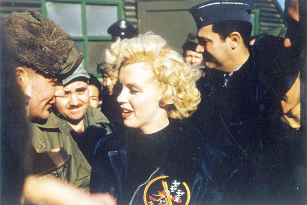Monroe is among Air Force personnel and wearing a 6147th Tactical Control Group jacket. (U.S. Air Force photo)
