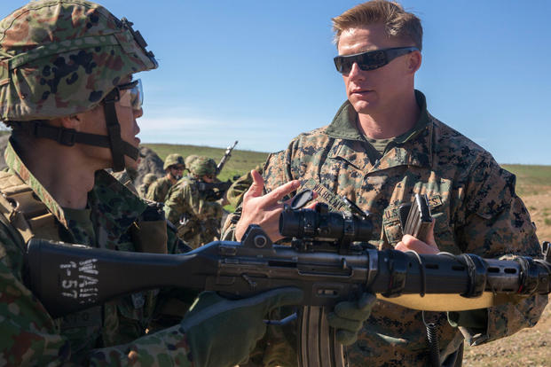 Sgt. Mason Wilhelmy discusses the Japan Ground Self-Defense Force’s Western Army Infantry Regiment’s Scout Sniper program with Sgt. First Class Kusumato at Marine Corps Base Camp Pendleton, Calif., Feb. 1, 2016. (Photo: Lance Cpl. Timothy Valero)