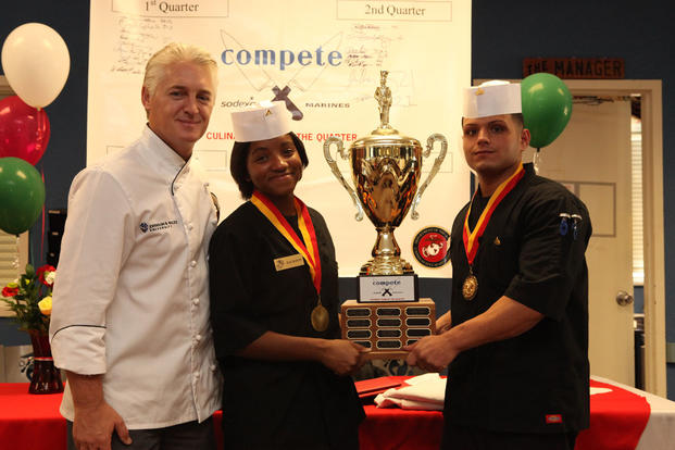 Mark Allison, the dean of culinary arts for Johnson and Wales University, with Lance Cpl. Charmaine Jackson and Cpl. Frank Cala after they won the third quarter Culinary Team of the Quarter, Oct. 18, 2011. (U.S. Marine Corps/Cpl. Damany S. Coleman)