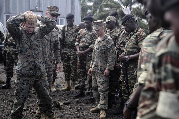 Lance Cpl. Christopher Parsons and Lance Cpl. Dustin Kitts show Cameroonian soldiers how to conduct personnel searches in Limbé, Cameroon, June 30, 2016. (Photo: Cpl. Alexander Mitchell)