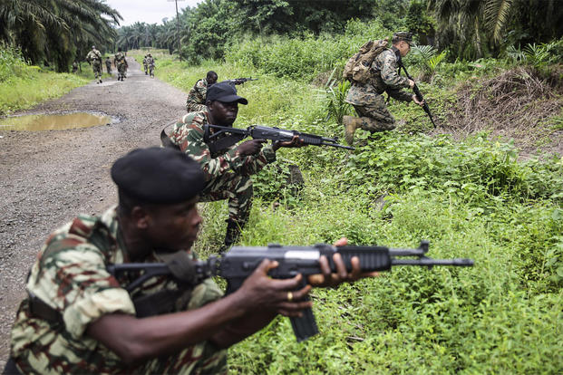 Cpl. Mitchell York rushes forward during a simulated contact left attack during a patrolling exercise with Cameroonian soldiers in Limbé, Cameroon, June 28, 2016. (Photo: Cpl. Alexander Mitchell)