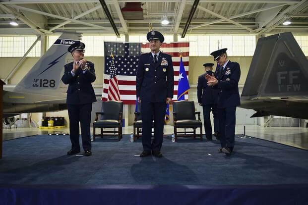 U.S. Air Force Chief of Staff Gen. David L. Goldfein and General Hawk Carlisle applaud for Gen. James M. Holmes during ACC’s Change of Command ceremony at Joint Base Langley-Eustis, Va., March 10, 2017 (U.S. Air Force/Kimberly Nagle)