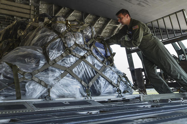A loadmaster from the 15th Airlift Squadron at Joint Base Charleston loads cargo onto a C-17 July 23, 2017, at Little Rock Air Force Base, Ark. (U.S. Air Force photo/Staff Sgt. Harry Brexel)