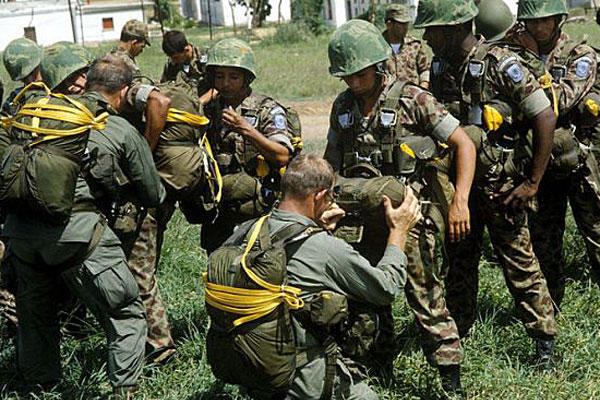U.S. Army soldiers check the equipment of Colombian paratroopers. DoD photo