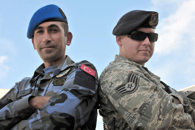 A Turkish Air Force Security Forces patrolman, (left) and Staff Sgt. Ryan Schaefer (right) work as a team during a joint patrol Oct. 22, 2010, at Incirlik Air Base, Turkey. Patrolmen (U.S. Air Force photo/Senior Airman Ashley Wood)