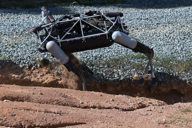 "Spot", a quadruped prototype robot, maneuvers through a ditch during a demonstration at Marine Corps Base Quantico, Va., Sept. 16, 2015. Photo By: Sgt. Eric Keenan