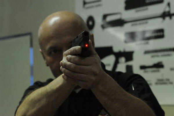 Peter Desjardin, Air Force Global Strike Command, aims a laser sight during a Women's Introduction to Firearms class on Barksdale Air Force Base, La., April 26, 2013. (U.S. Air Force photo/Airman 1st Class Andrew Moua)