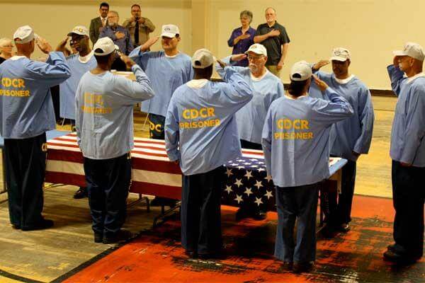 Members of the Incarcerated Vietnam Veterans of America (IVVA), Chapter 1065, at the Correctional Training Facility (CTF) salute before folding the U.S. flag. (Photo: Inside CDCR)