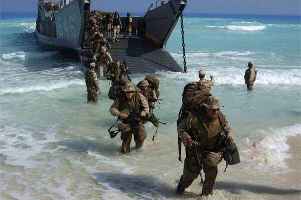 U.S. Marines from Expeditionary Strike Group One, 13th Marine Expeditionary Unit wade ashore in preparation for an amphibious assault landing demonstration in Mubarek Military City, Egypt, on Sept. 13, 2005.  (Airman Apprentice Shannon Garcia, U.S. Navy.)