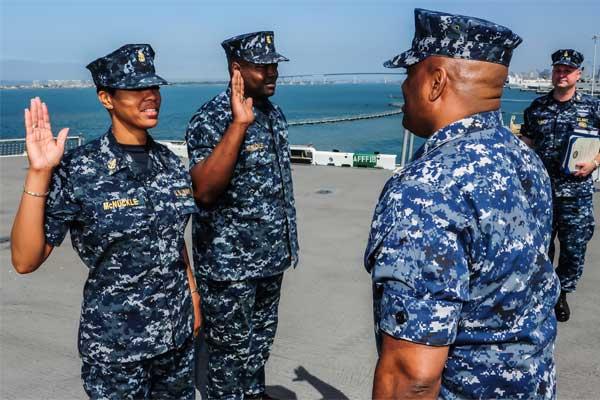 Master Chief Personnel Specialist Jay McNuckle and his wife Senior Chief Master-at-Arms Latisha McNuckle re-enlist together on the amphibious assault ship USS Boxer (LHD 4). (U.S. Navy photo by Mass Communication Specialist 3rd Class Brian Jeffries)