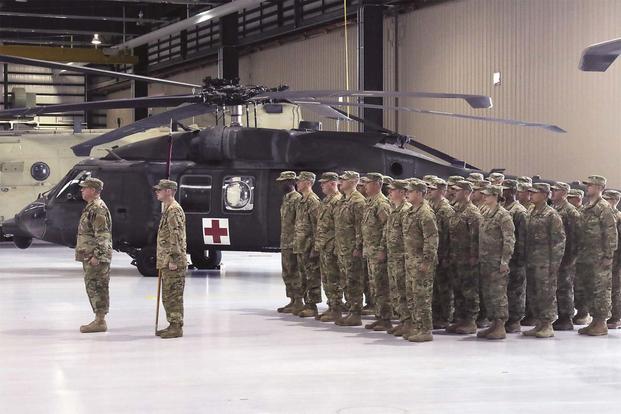 Soldiers of Company C, 2nd General Support Aviation Battalion, 1st Aviation Regiment, 1st Combat Aviation Brigade, 1st Infantry Division, sing the “Big Red One” song during a deployment ceremony at Fort Riley July 13. (Sgt. Jarrett Allen)