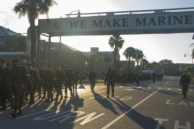 Recruits hike under the iconic "We Make Marines" sign during the Crucible Aug. 26, 2016, on Parris Island, S.C. (Photo by Lance Cpl. Aaron Bolser)