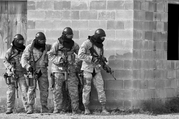 A team of 96th Security Forces Squadron Airmen prepare to enter a building during a shoot, move and communicate drill in June at Eglin Air Force Base, Fla. (U.S. Air Force photo/Samuel King Jr.)