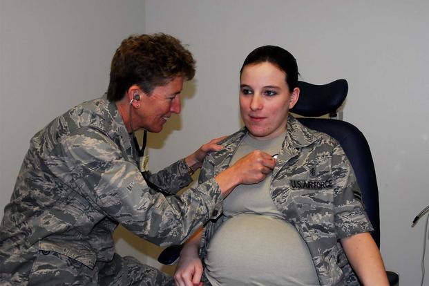 Airman First Class Brandy Fraher, who is in the final stages of her pregnancy, receives an examination from Major Noreen Burke during a unit training assembly. (Air Force Photo)