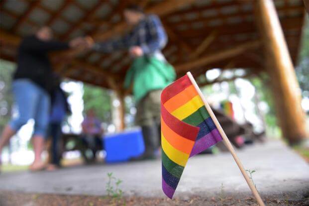 A rainbow flag is placed in the ground for Lesbian, Gay, Bisexual and Transgender Pride Month during the Picnic in the Park at Nussbaumer Park, June 27, 2015, in Fairbanks, Alaska. (U.S. Air Force photo by Senior Airman Ashley Nicole Taylor/Released)