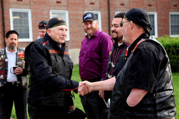 Dr. Bruce Heilman, left, 89, a World War II Marine veteran, greets Bill Watson of the Band of Brothers Motorcycle Club during his April 2015 visit to Marine Corps Base Quantico. (US Marine Corps/David White)