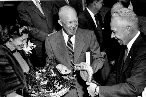 November 14, 1954: President Dwight D. "Ike" Eisenhower receives a turkey from the president of the National Turkey Federation. Ike liked to have a bourbon "punch" in his holiday eggnog. (Eisenhower Presidential Library photo)