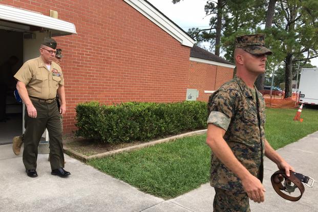 Col. Daniel Hunter Wilson, left, leaves the courtroom at Camp Lejeune, N.C., Sept. 9, 2017, after being found guilty of molesting a six-year-old girl. (Photo by Hope Hodge Seck/Military.com)