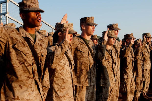 Marine recruits renew their oath of enlistment at Marine Corps Recruit Depot Parris Island. One of the base's drill instructors is going on trial more than a year and a half after the suicide of a 20-year-old recruit. (US Marine Corps photo/MaryAnn Hill)