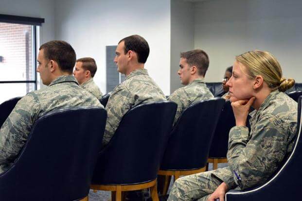Service members attending a meeting.