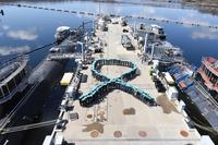 Crew members assigned to the USS North Dakota and USS Virginia form in the shape of a teal-colored ribbon on Wednesday, April 11, 2018, at Naval Submarine Base, New London to support Sexual Assault Awareness and Prevention Month. (U.S. Navy/Christian Porter)