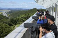 Visitors watch the North Korea side from the Unification Observation Post in Paju, South Korea