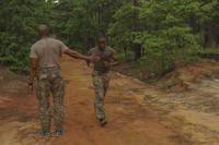 A paratrooper with the 2nd Battalion, 501st Parachute Infantry Regiment, 82nd Airborne Division. encourages his battle buddy to complete a 5-mile run during the Ranger Physical Assessment Test on Fort Bragg, N.C.