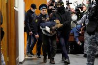 A suspect in a deadly attack is escorted by police in Moscow, Russia.