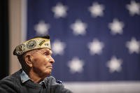 Pearl Harbor survivor Dick Higgins listens to a speaker during a ceremony