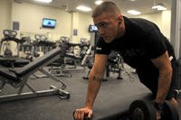Senior Airman Kyle Honeycutt performs one-arm dumbbell rows at Creech Air Force Base, Nev.