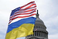 The American and Ukrainian flags wave in the wind outside of the Capitol