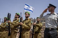 Israeli honor guard soldiers salute during the funeral of Israeli reserve Major Dor Zimel