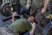 U.S. Marine Corps Sgt. Michael Watson II, aviation logistics information management system specialist, Marine Aviation Logistics Squadron (MALS) 31, Marine Aircraft Group 31, 2nd Marine Aircraft Wing, performs a barbell bench press during MALS-31’s field meet at Marine Corps Air Station Beaufort, South Carolina.