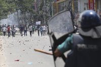 Students clash with riot police during a protest