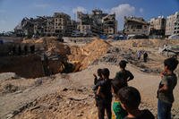 Palestinians watch as Egyptian machinery and workers search for the bodies of hostages in Hamad City, Khan Younis, in the southern Gaza Strip, Tuesday, Oct. 28, 2025. (AP Photo/Abdel Kareem Hana) APTOPIX Israel Palestinians Gaza