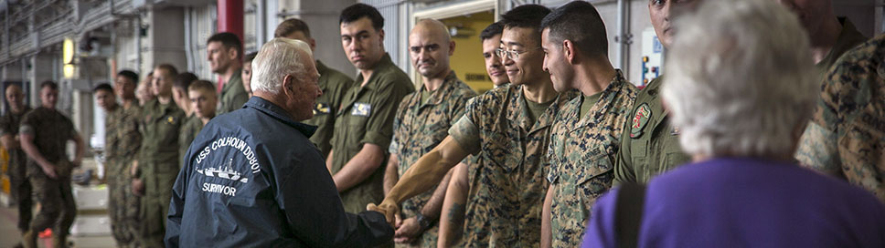 Donald Irwin, a U.S. Navy veteran of World War II, shakes Lance Cpl. Hui Xue’s hand, April 7, 2017, on Marine Corps Air Station Futenma, Okinawa, (U.S. Marine Corps/Amaia Unanue)