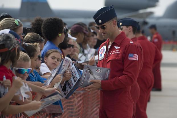 Lt. Col. Jason Heard of the U.S. Air Force Thunderbirds Air Demonstration Squadron and pilot of the No. 1 jet, signs autographs after completing a performance Aug. 27, 2017, at Dover Air Force Base, Del. (U.S. Air Force/Zachary Cacicia)