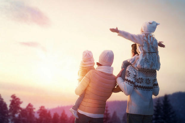 A family on a mountain in winter